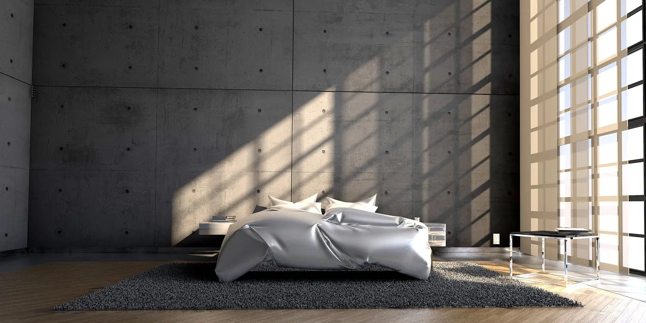 A sculptural bed in a raw concrete room