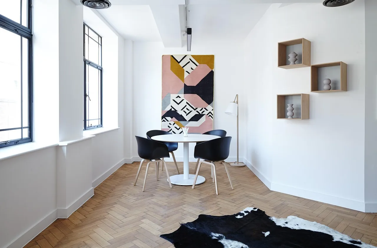 A pale dining room with a single artwork